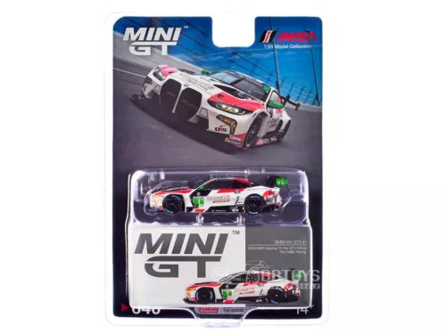 Die-cast race car model in blister pack, white with red and green accents.