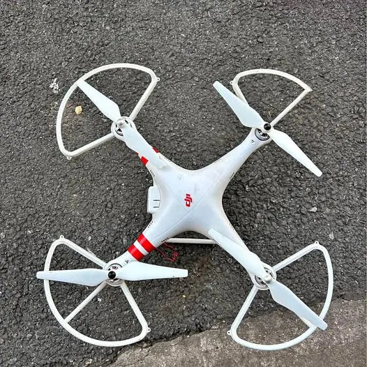 White quadcopter drone with four propellers, front view