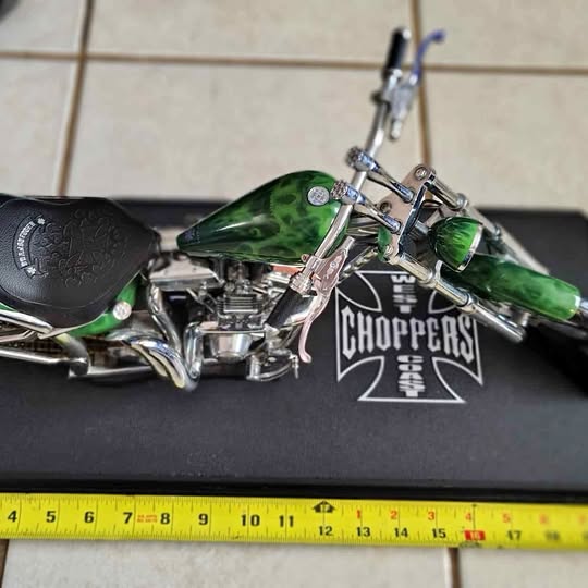 Diecast chopper bike with green fuel tank, black seat, chrome engine and handlebar detail