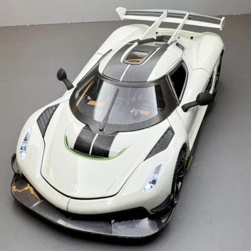 White 1:24 diecast model car with detailed hood and windshield, front three-quarter view