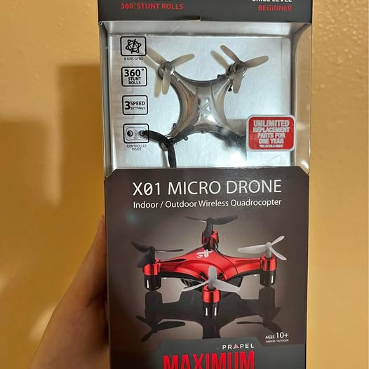 Red micro quadcopter drone in retail box, 4-rotor design, wireless control