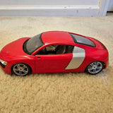1:18 scale Audi R8 diecast vehicle, red coupe with black hood and roof, silver side stripe