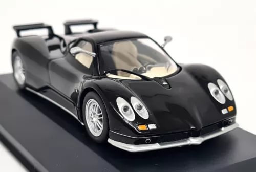 Black Pagani Zonda C12 S diecast model car, front 3/4 view with headlights