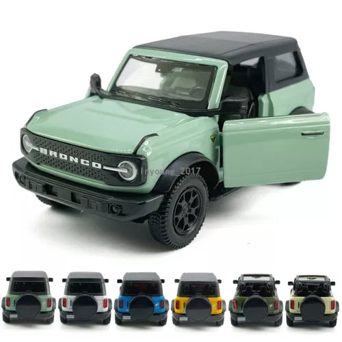 Mint green Ford Bronco diecast model car with black roof, front three-quarter view