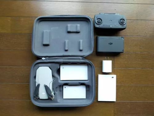 DJI Mavic Mini drone accessory kit with controller, screens, cables, and case