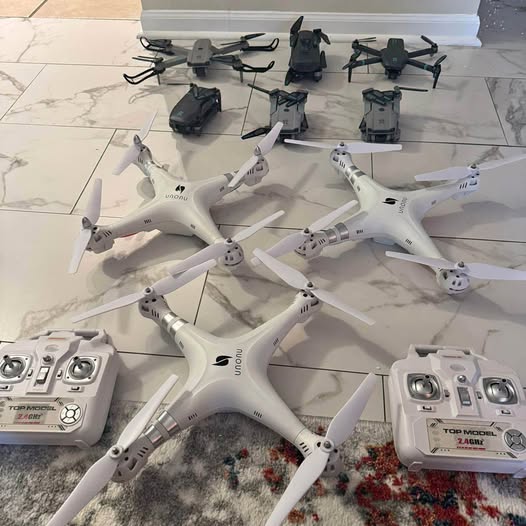 White quadcopter drone set with controllers, multiple units