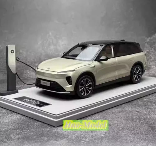 Cream alloy diecast electric car model with black wheels and roof, front three-quarter view.