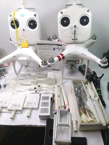 DJI Phantom camera drone parts set with two white drone bodies