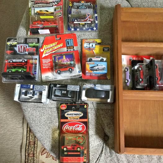 1/64 diecast car boxes and a glass display case with cars inside