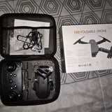 Foldable mini drone in zippered carrying case with controller and instruction sheet