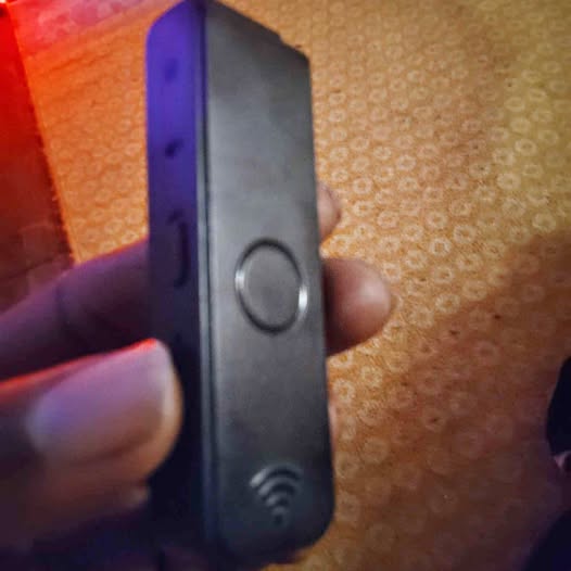 Bodycam drone device, black rectangular with oval button and side sensor
