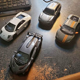 Kinsmart 1:36 diecast sports car set of four, with silver and dark finishes
