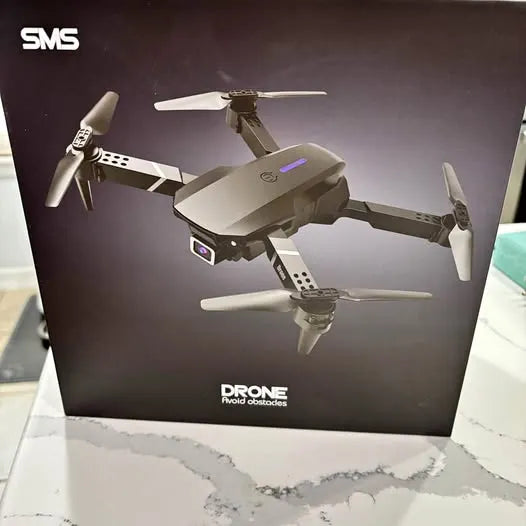 Folding quadcopter drone with four propellers and front camera, gray