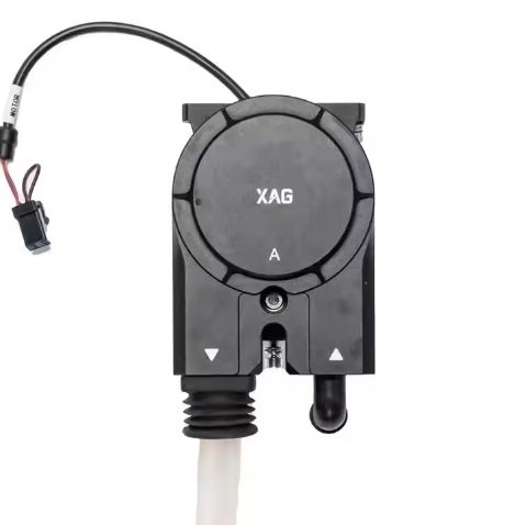 Peristaltic pump head with circular XAG label, dark housing, inlet and outlet ports
