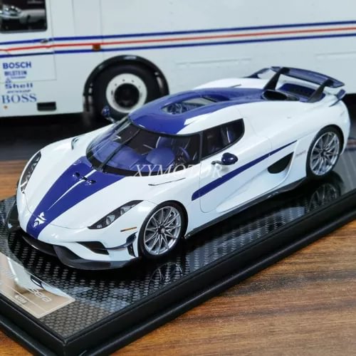 1/18 diecast model car, white with blue racing stripes and silver wheels, front 3/4 view