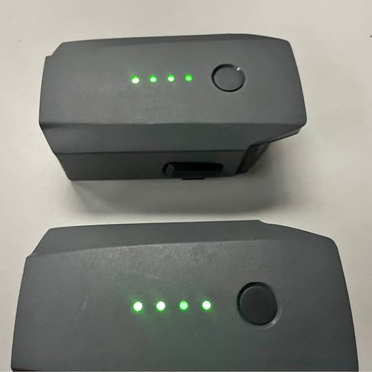Drone battery pack with LED status lights and round power button, dark gray