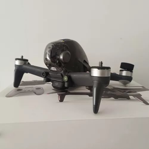 Black DJI FPV drone body with attached propellers and front camera module