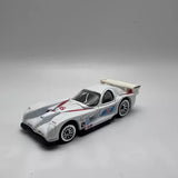 Hot Wheels 1:64 diecast race car, white #66 with rear wing, front 3/4 view
