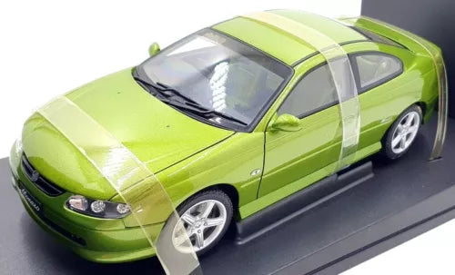 Metallic green 1:18 diecast coupe model with chrome wheels, front view