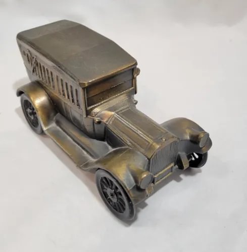 Metal diecast car coin bank, coppertone vintage Packard-style with front grille and wheels