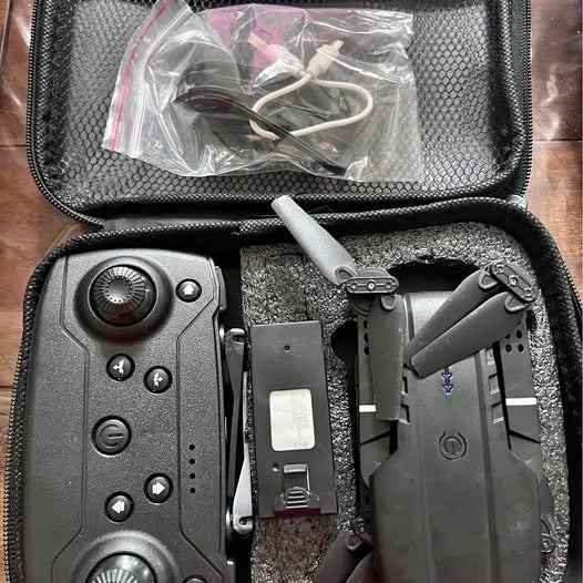 Drone kit in protective case with controller and folded quadcopter
