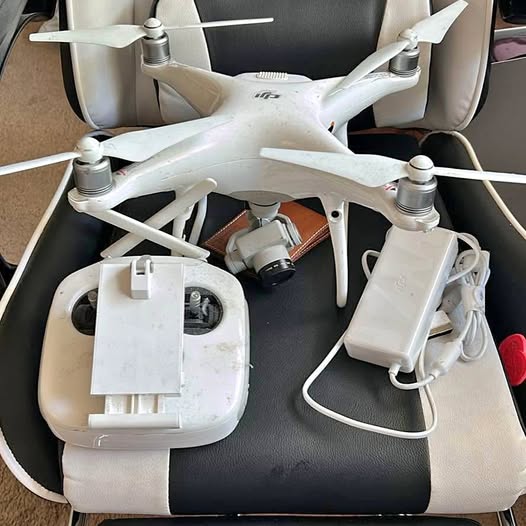 White quadcopter drone with propellers in zip case