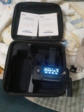 Black hard drone case with blue controller inside, foam cutouts visible.
