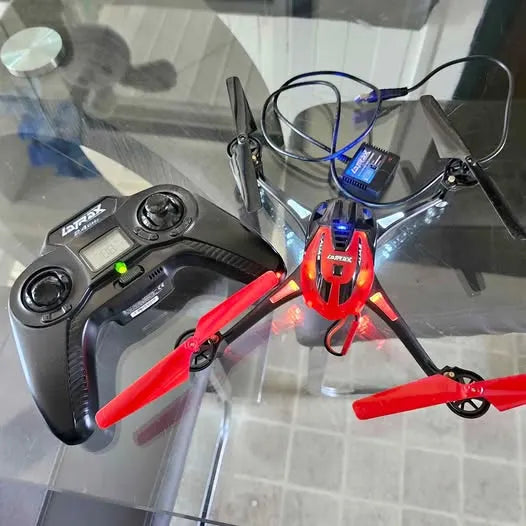 Red quadcopter drone with black prop guards and blue lights, with remote controller