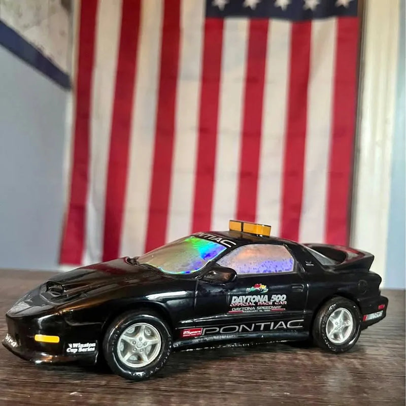 Black Pontiac Trans Am Daytona 500 pace car diecast with decals and yellow roof light
