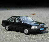1:18 scale black sedan diecast model car, front 3/4 view with silver grille