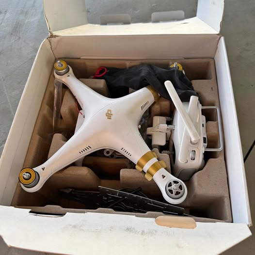 White quadcopter drone with propellers and camera module