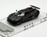 Black diecast sports car model with pink accents, on clear display base, front 3/4 view