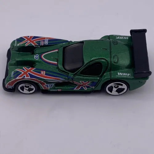 Green 1:64 diecast race car with Union Jack stripes and black rear wing