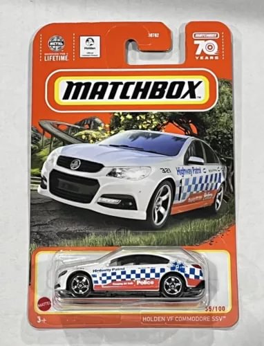 White and blue police diecast toy car in Matchbox blister packaging