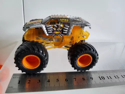 Orange monster truck diecast with black oversized tires and grey details
