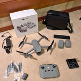 Foldable quadcopter drone kit with controller, spare batteries, props, and carrying case