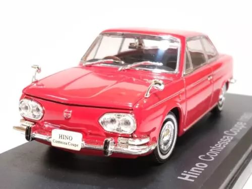 Red 1965 coupe diecast model, front 3/4 view with chrome bumper and grille.