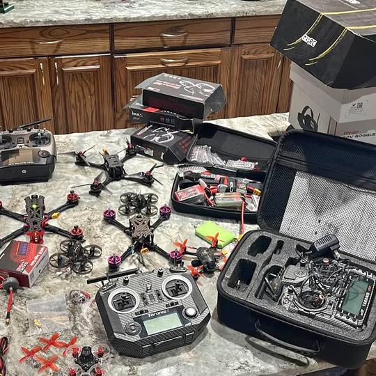 FPV drone equipment kit with multiple small drones, controller, and hard case
