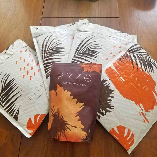 RYZE mushroom coffee packets with leaf and orange print, brown pouch
