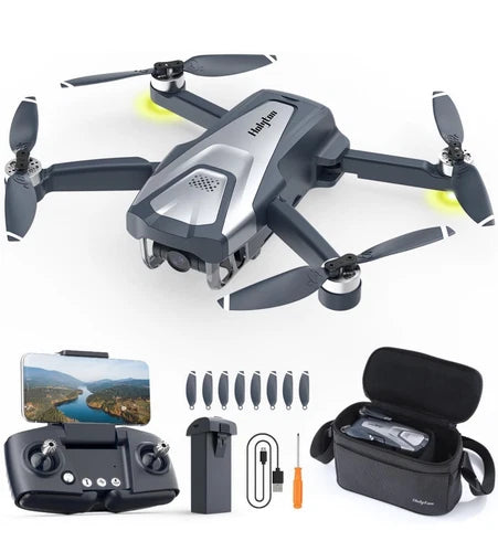 Gray quadcopter drone with camera, remote controller, and accessory kit