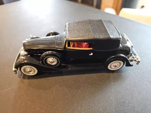 Black 1:48 scale diecast classic Packard car model with detailed interior