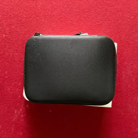 Black hard-shell drone carrying case with rounded corners and zipper edge
