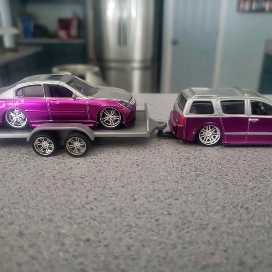 Purple and silver diecast model SUV with chrome wheels and tinted windows