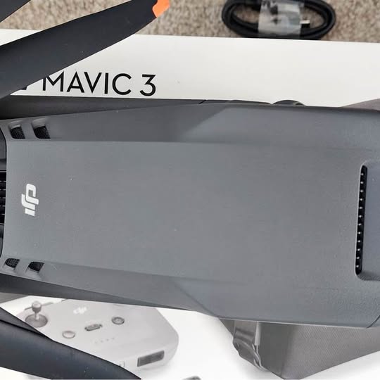 Folded gray DJI drone body with arm and rear opening