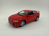 Red diecast pull-back toy car, front 3/4 view, Mitsubishi Lancer Evolution X style