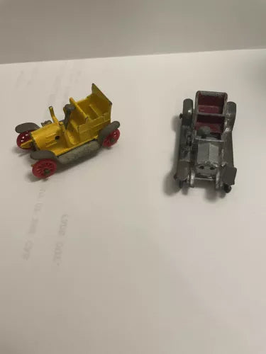 Vintage miniature diecast cars, yellow open-wheel and silver with red seats