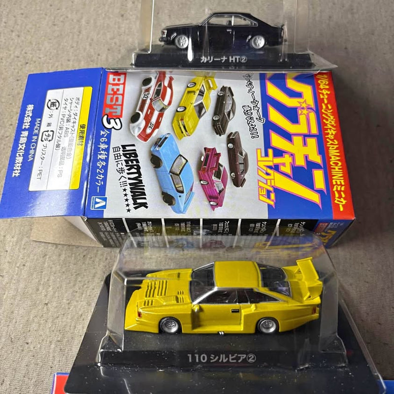 Yellow diecast sports car model in clear display case with box packaging