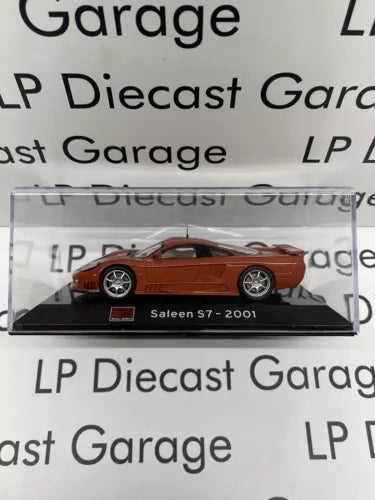Burnt orange diecast Saleen S7 model car in display case, labeled S7-2001, 1:43