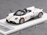 White open-top sports diecast car model on display base, side view with logo