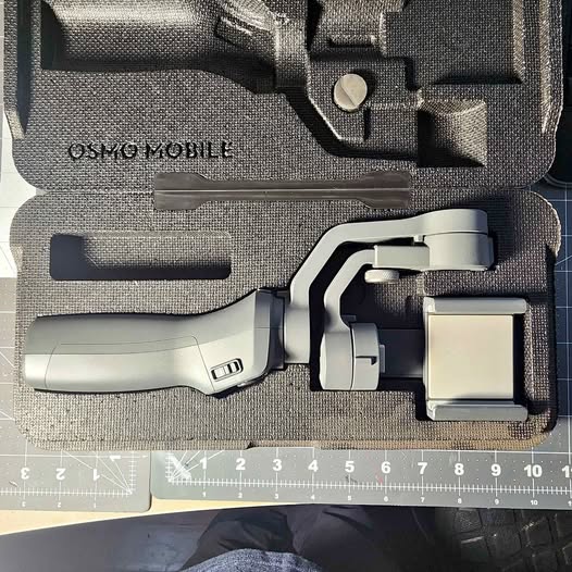 DJI Osmo Mobile 2 gimbal stabilizer with handle and accessories in hard case